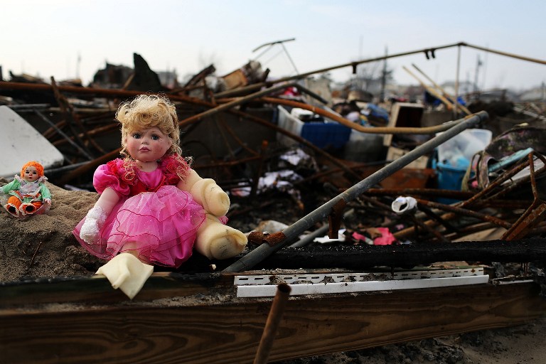 SANDY'S DEVASTATION. A toy doll is viewed on the remains of homes December 4, 2012 in the Breezy Point neighborhood of the Queens borough of New York City. Breezy Point, home to many New York City firefighters and police, lost 111 homes in a fast moving fire during Superstorm Sandy with many more homes severely damaged from flooding. Photo by Spencer Platt/Getty Images/AFP