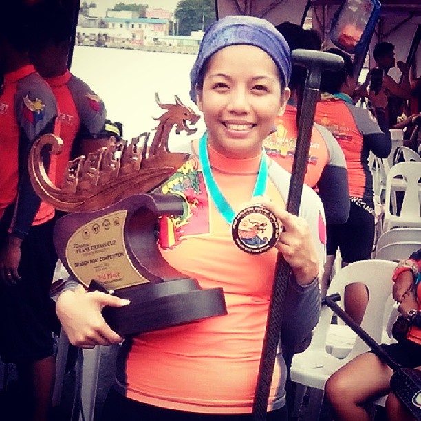 The author holds her hardware from the 2013 Frank Drilon Cup