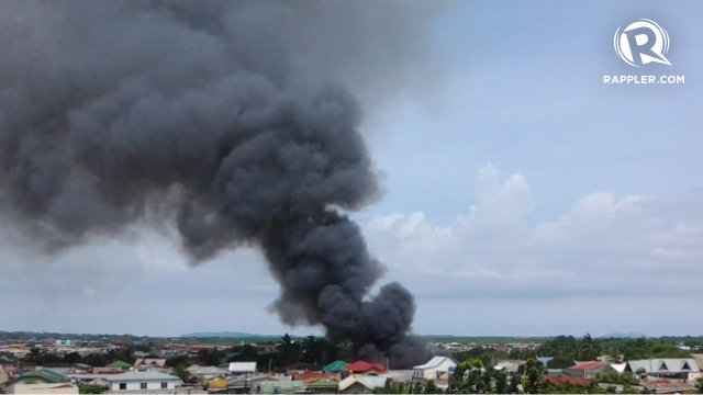 FIRE IN ZAMBO. Firefighters are having a hard time entering the barangay because of MNLF rebels in the area. Photo by Richard Falcatan
