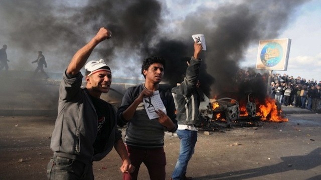 CLASH. Egyptian protesters shout slogans in front of burning cars set on fire during a demonstration calling for a "No" vote in a referendum on a new constitution in Alexandria. AFP Photo