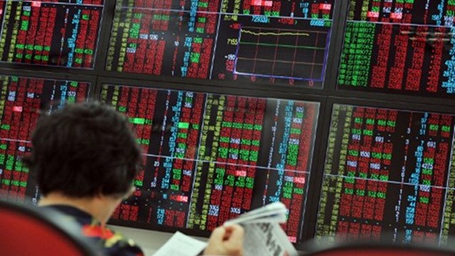 TUMBLING STOCKS. A trader monitors stocks at a securities company in Taipei. File picture by AFP 