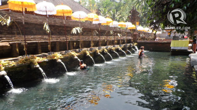 HOLY WATER.  Devout Hindus bathe and even tourists them- selves with water that is Believed to have healing powers.