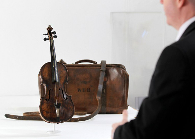 SOLD. Recovered violin of Wallace Hartley, bandmaster of the doomed Titanic. Photo: Peter Muhly/AFP