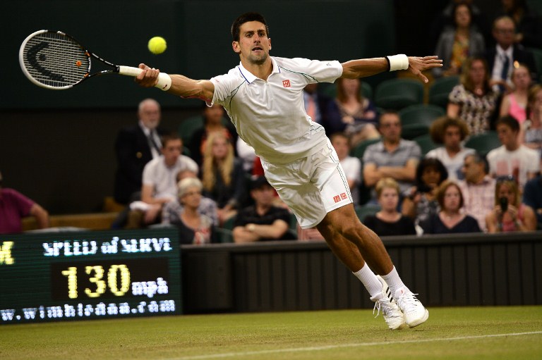 Serbia's Novak Djokovic plays a shot during his second round men's singles match against US player Ryan Harrison on day three of the 2012 Wimbledon Championships tennis tournament at the All England Tennis Club in Wimbledon, southwest London, on June 27, 2012. AFP PHOTO / ANDREW YATES 