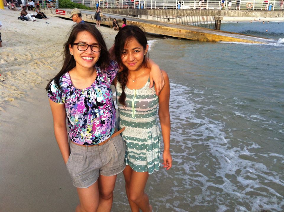 HAPPILY BROWN. The author (right) and a friend enjoy the beach in Singapore 
