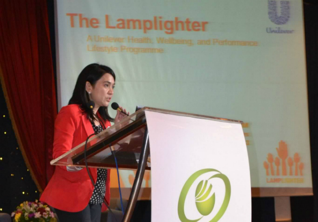 WELLNESS AT WORK. Dr Marge Lazaro-Leachon speaks to an audience of health specialists and businessmen about the benefits of a wellness program in the workplace. Photo from GT-Metro Foundation