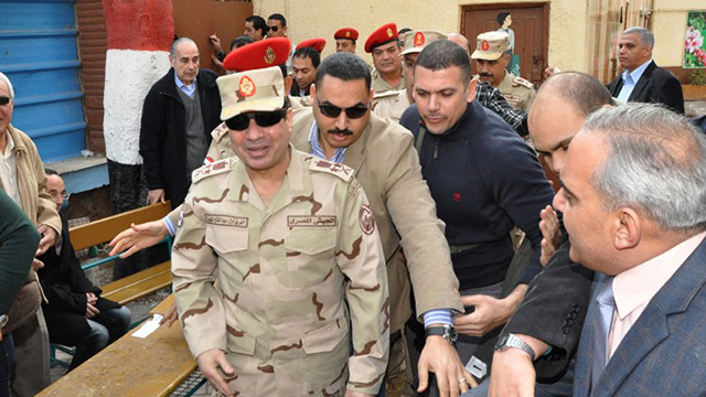EYES ON SISI. A handout picture released by the Egyptian army shows Egypt's Defense Minister, Army Chief Abdel Fattah al-Sisi (center) visiting a polling station in Cairo. AFP photo