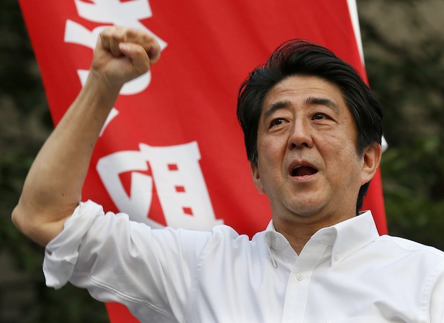 MORE ABENOMICS? Japanese Prime Minister Shinzo Abe raises his fist to appeal support to his party during the final campaign of the Upper House election in Tokyo, Japan, 20 July 2013. Photo by EPA/Kimimasa Mayama