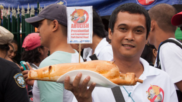 DAILY PORK. A protestor holds up a loaf of bread shaped like a pig at the August 26 #MillionPeopleMarch in Luneta