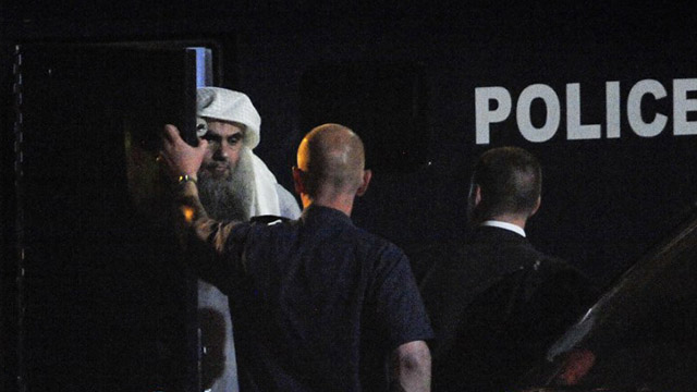 ABU QATADA. A handout picture from the British Home Office shows radical Islamist cleric Abu Qatada stepping out of a police van before boarding a privately chartered jet at the RAF Northolt base in west London, early on July 7, 2013, as he gets deported to Jordan. AFP PHOTO/ HO / SGT RALPH MERRY ABIPP RAF / MOD CROWN