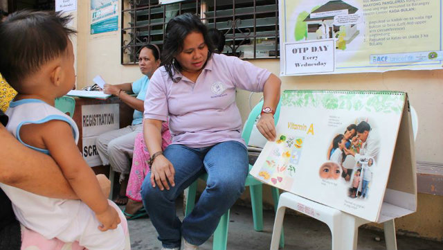 NUTRITION EDUCATION. A health worker explains the importance of micronutrients to a mother and her child. Photo from ACF International Philippines