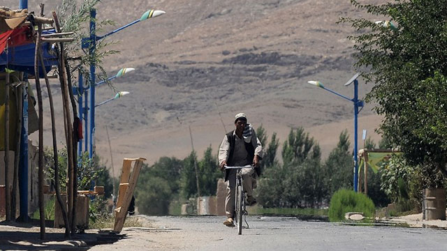 EMPTY. An Afghan man rides a bicycle on a deserted road outside a polling center at Baraki Barak district in Logar Province on Aug 20, 2009. File photo by Manan Vatsyayana/AFP