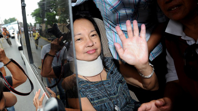 TEMPORARY RELEASE? Arroyo waves at supporters upon arriving home in Katipunan, Quezon City. AFP Photo