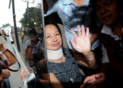 TEMPORARY RELEASE? Arroyo waves at supporters upon arriving home in Katipunan, Quezon City. AFP Photo.