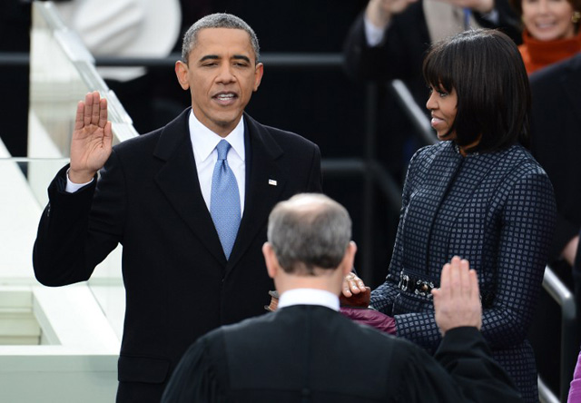 SECOND TERM. US President Barack Obama takes the oath of office during the 57th Presidential Inauguration ceremonial swearing-in at the US Capitol on January 21, 2013 in Washington, DC. The oath is administered by US Supreme Court Chief Justice John Roberts, Jr. Obama is joined by US First Lady Michelle Obama. AFP PHOTO/Emmanuel Dunand