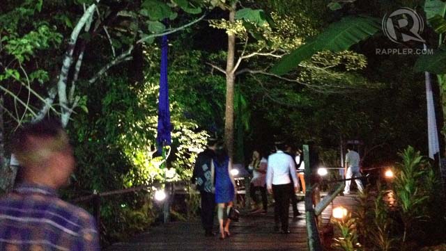 Delegates on a wooden walkway around the forest, going from one location to another