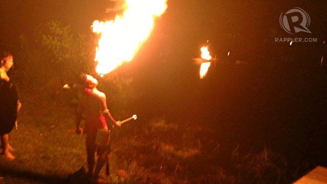 A fire blower lights up the dark lake