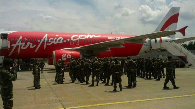 'NOW EVERYONE CAN FLY' Malaysian soldiers wait to board an AirAsia commercial flight to Sabah. Photo from @tonyfernandes