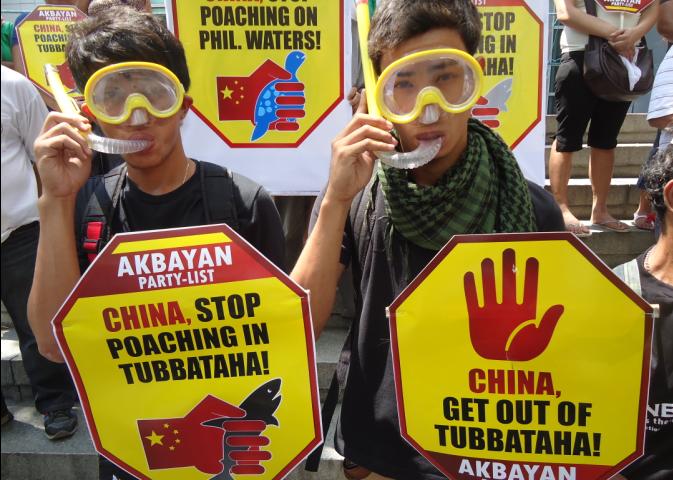 NOT AGAIN. Members of Akbayan troop to the Chinese Consular Office in Makati to protest the presence of a Chinese vessel in Tubbataha. Photo by Rappler/Jerald Uy 