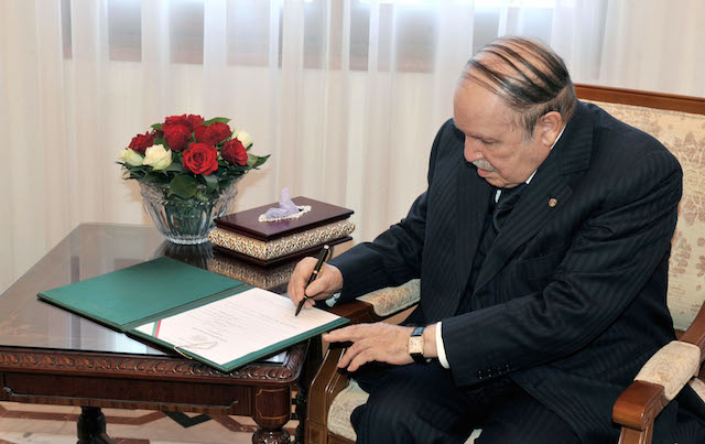 ANOTHER TERM? Algerian President Abdelaziz Bouteflika, shown in this March 3, 2014, file photo signing official presidential candidature documents, is favored to win a fourth term. EPA/APS Handout 
