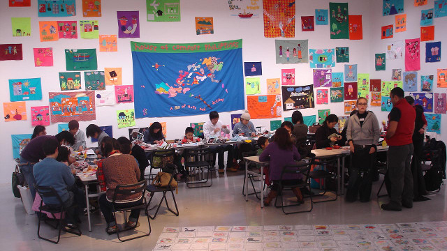 MAKING ART TOGETHER. Participants create works of art at the House of Comfort exhibit and workshop in 2008