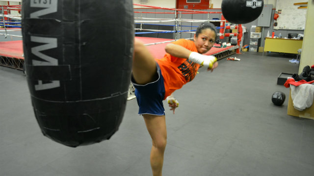 HURRICANE WARNING. Former boxing champion Ana Julaton throws a kick at the heavy bag. Photo from Julaton's website 