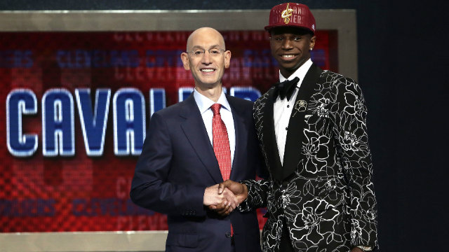 Andrew Wiggins (R) poses with NBA commissioner Adam Silver (L) after being selected number one overall by the Cleveland Cavs. Photo by Jason Szenes/EPA