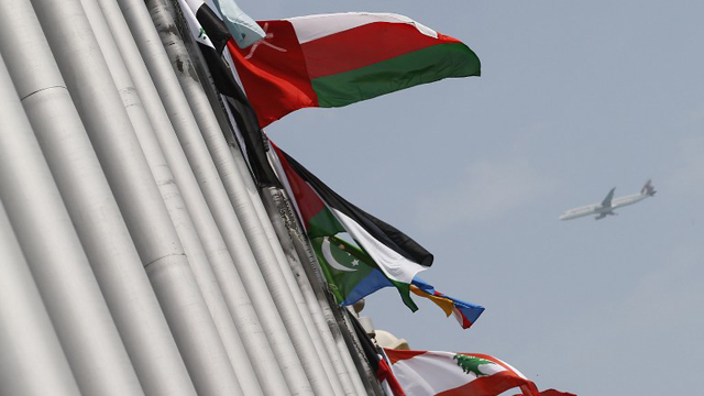 The flags of the 22 arab countries flutter outside the hotel that will host the 24th summit of the Arab League on March 25, 2013 in the Qatari capital Doha. AFP PHOTO/KARIM SAHIB