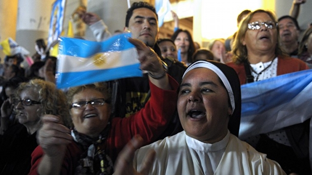A nun (C) and faithful celebrate after Argentine cardinal Jorge Mario Bergoglio was elected as new Pope, outside the Metropolitan Cathedral in Buenos Aires on March 13, 2013. Argentina's Jorge Mario Bergoglio was elected Pope Francis I on Wednesday, becoming the church's first Latin American pontiff after a conclave to elect a leader of the world's 1.2 billion Catholics. AFP PHOTO / Alejandro PAGNI