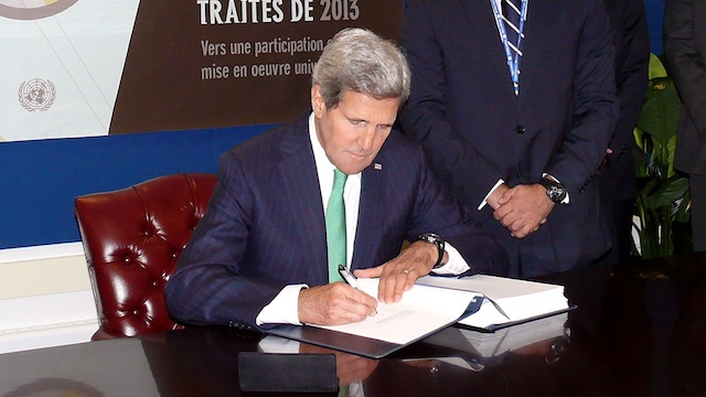 TREATY SIGNATORY. US Secretary of State John Kerry signs the UN Arms Trade Treaty (ATT), the first international treaty regulating the global arms trade in conventional arms, at the UN headquarters in New York, 25 September 2013. UN Photo/Win Khine