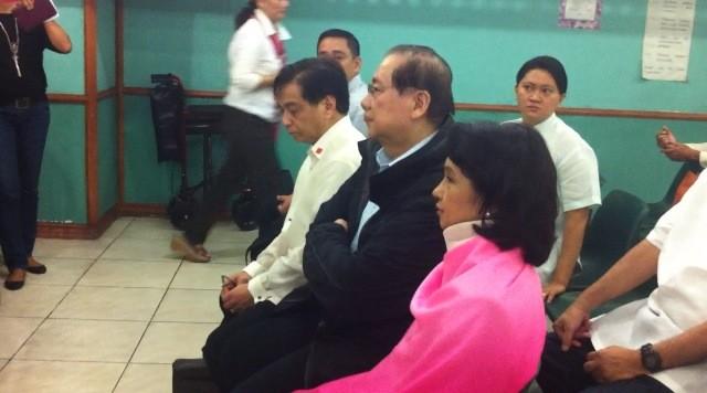 Former president Gloria Arroyo (C) awaits the start of the arraignment of the PCSO plunder case at the Sandiganbayan, October 29, 2012. Photo by Natashya Gutierrez.