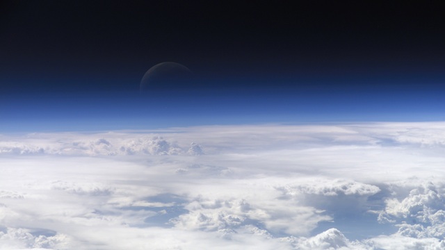 ABOVE THE EARTH. This astronaut photograph captured on 8 July 2011, shows a nearly translucent moon emerging from behind the halo formed by the Earth's visible atmosphere. Image courtesy NASA/DVIDSHub