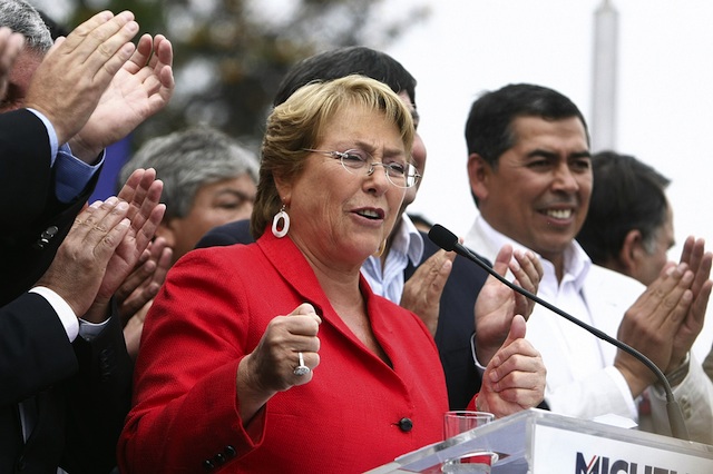FRONTRUNNER. Former president Michelle Bachelet (L), delivers a speech in the San Ramon neighborhood in Santiago, Chile, 18 November 2013. EPA/Mario Ruiz