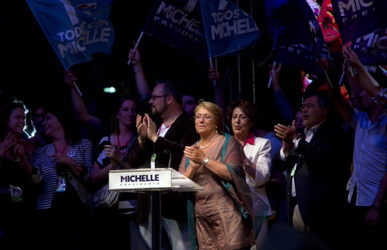 PRESIDENT ONCE MORE. Chilean president-elect, Michelle Bachelet, applauds as she delivers a speech after getting the results of the run-off presidential election in Santiago on December 15, 2013. AFP/Claudio Reyes