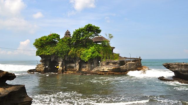 TANAH LOT, WHETHER AT high tide with the pounding surf or at low tide with a colorful sunset, is breathtaking
