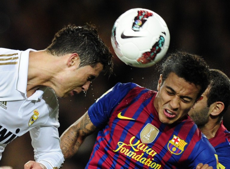 REAL MADRID'S CRISTIANO RONALDO (L) and FC Barcelona's Thiago Alcantara fight for the ball during last season's El Clasico game in the Camp Nou. Photo by AFP
