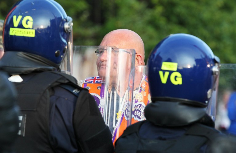 FACE OFF. A Orangemen confronts riot police as a small protest is stopped along Shankill road in north Belfast, Northern Ireland on July 13, 2013. Photo by AFP / Peter Muhly