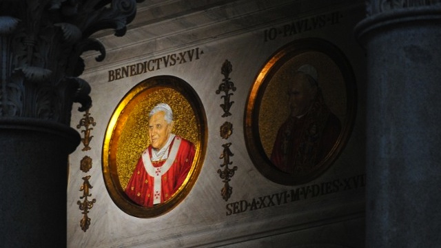 OUTGOING POPE. The portrait of Pope Benedict XVI (L) is displayed next to Pope John Paul II's on a wall of the St Paul Outside the Walls’ basilica on February 13, 2013 in Rome. The portraits of each pope are displayed in a frieze extending above the columns separating the four aisles and naves. AFP Photo/Tiziana Fabi