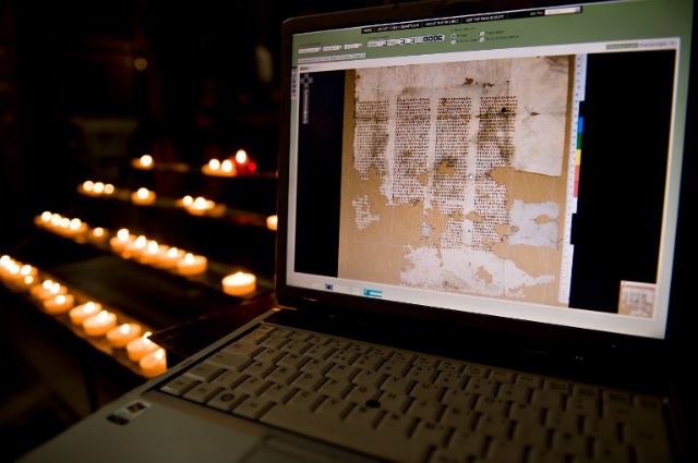OLD AND NEW. Pages of the Codex Sinaiticus, the world’s oldest surviving Christian Bible, are pictured on a laptop in Westminster Cathedral, central London, on July 6, 2009. Various means, like this digital copy, enrich faith in the Internet age. File photo by Leon Neal/AFP