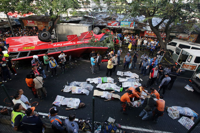 CARNAGE. Rescue workers extract the bodies of still unidentified persons from the wrecked bus. Photo by EPA/Francis Malasig