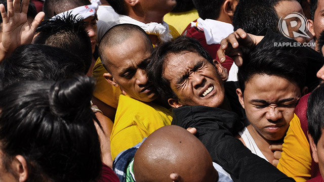 DEVOTION. A man is squeezed among crowd during the annual procession of the Black Nazarene in Manila on Thursday. Photo by Jay Ganzon