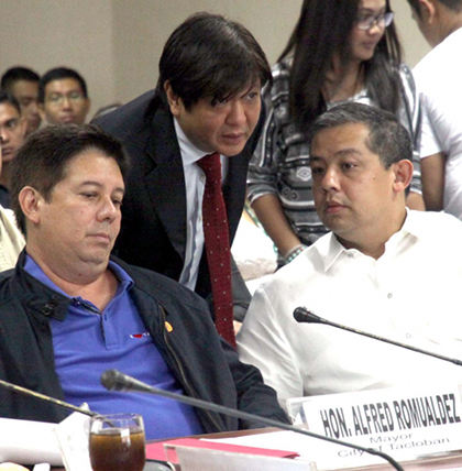 'CHRISTMAS WISH.' Senator Bongbong Marcos says after his cousin's feud with Secretary Roxas, he hopes there will be no more politics in the Yolanda rehabilitation effort. In this photo, Marcos talks to his cousins Tacloban Mayor Alfred Romualdez (left) and  Leyte 1st district Representative Martin Romualdez (right) during a Senate hearing on typhoon Yolanda. File photo by Romy Bugante/Senate PRIB