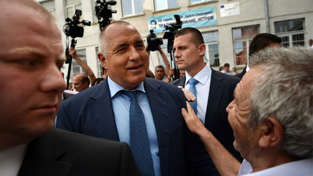 Sofia, Bulgaria - An elderly man greets Boyko Borisov (C), the leader of the Bulgarian conservative GERB party and a former Prime Minister after casting his vote in Sofia on May 12, 2013. Bulgarians began voting in a tight and tense snap general election marred by accusations of fraud and expected to result in political stalemate and fresh protests in the EU's poorest member. AFP PHOTO / DIMITAR DILKOFF