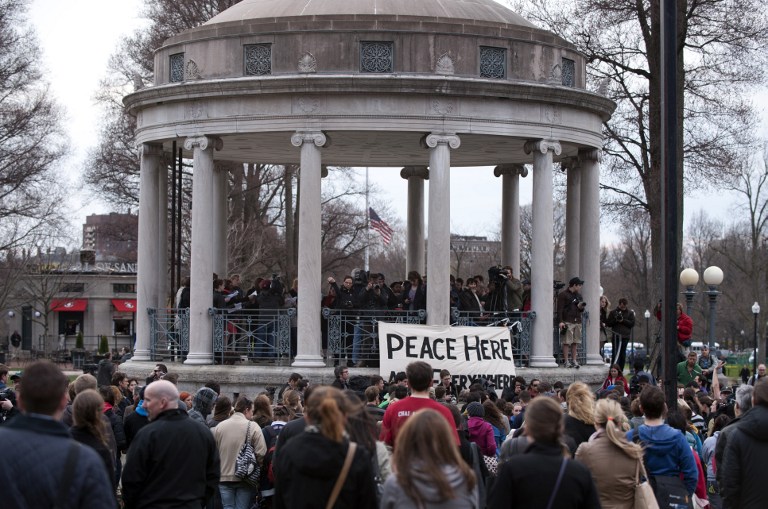 'PEACE HERE' People gather in the Boston Commons for a vigil on April 16, 2013 in Boston, in the aftermath of two explosions that struck near the finish line of the Boston Marathon on April 15. AFP PHOTO/Don Emmert