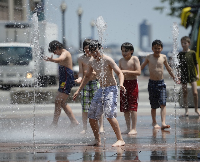 COOLING DOWN. Children play in a water fountain along the Greenway as high levels of humidity and temperatures approached 95ºF (35ºC) in Boston, Massachusetts, USA 31 May 2013. EPA/CJ Gunther