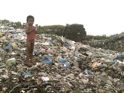 THEY GROW UP HERE. Kids are used to trash in their neighborhood. Photo by Nikki Luna
