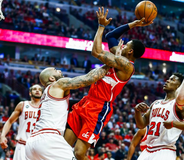 MAGIC TIME. Washington Wizards guard Bradley Beal puts a shot up with Chicago Bulls forward Carlos Boozer’s hand in his face. Photo by Tannen Maury/EPA