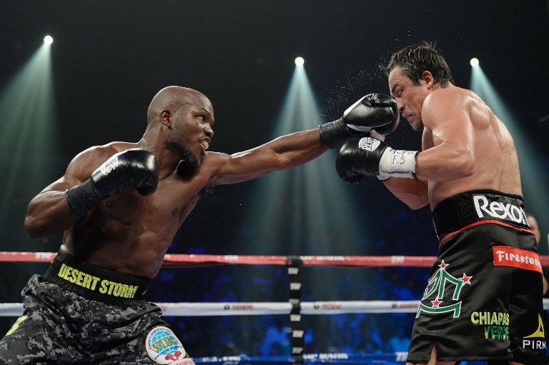 SPLIT-DECISION TRIUMPH. WBO welterweight champion Timothy Bradley Jr. (L) lands a jab to the face of Juan Manuel Marquez during their bout at the Thomas & Mack Center on October 12, 2013 in Las Vegas, Nevada. Jeff Bottari/Getty Images/AFP