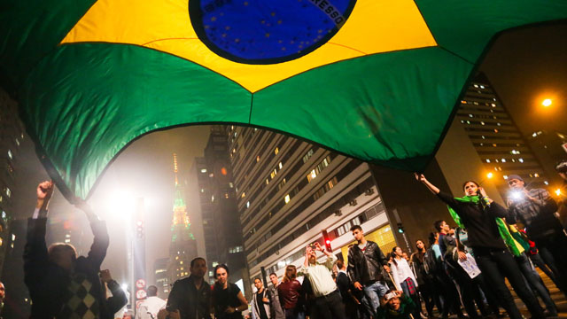 NATIONWIDE PROTESTS. Protesters in Sao Paolo flatter a Brazilian flag as more than a million turn out in various demonstrations in key cities throughout Brazil. Photo by EPA/Keiny Andrade.