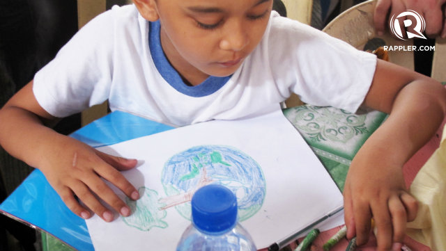 ON TOP OF THE WORLD. An Isabelo Delos Reyes Elementary student draws a picture at the arts and crafts table